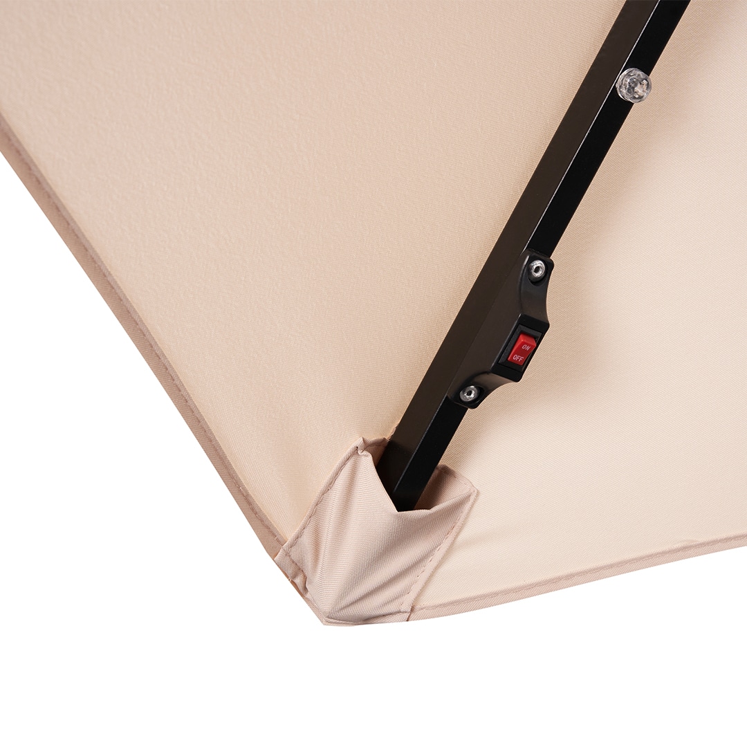 Cream-coloured umbrella with a cantilever stand for patio furniture